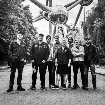Photo of the band members of Jaga Jazzist standing in front of an art installation